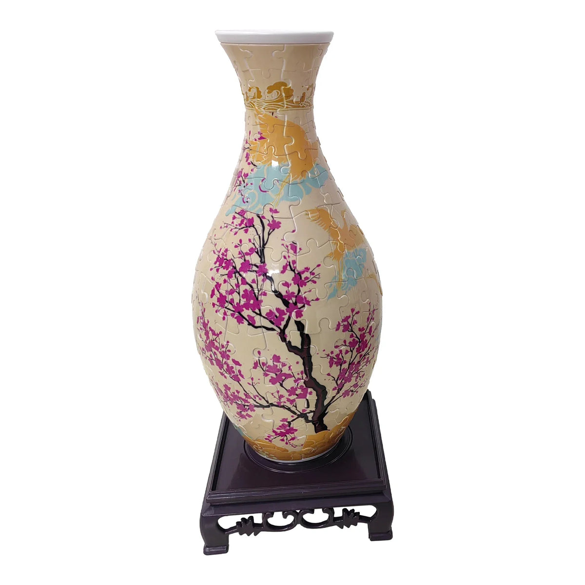 A ceramic vase decorated with pink and purple blossoms and gold accents, displayed on a dark wooden stand.