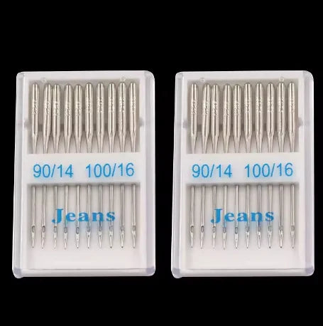 A set of stainless steel sewing machine needles for denim and jeans, packaged in clear plastic trays.