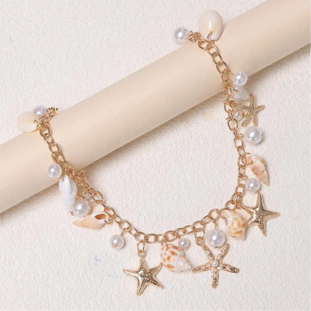 Gold chain accessory featuring starfish and pearl charms