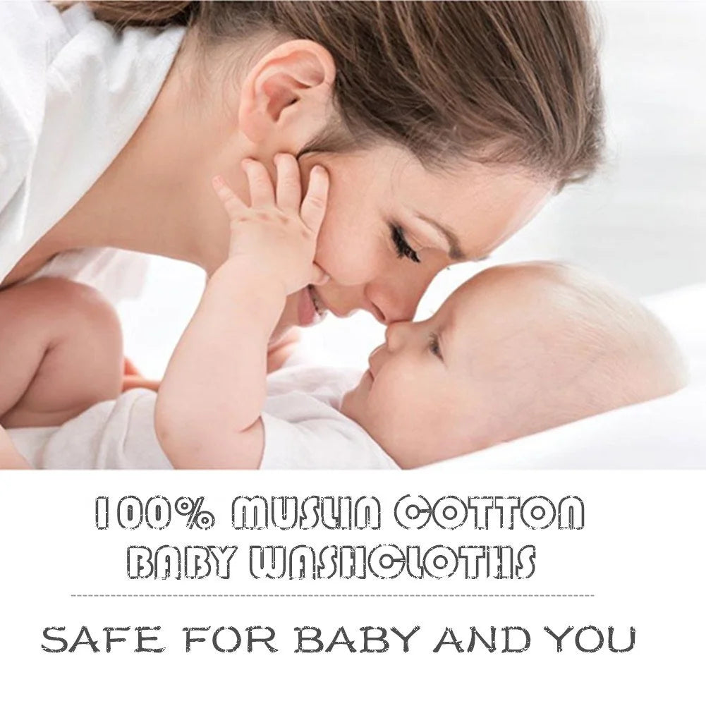 A mother tenderly kisses her baby on the forehead while using a muslin cotton baby washcloth.
