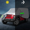 A gray Jeep Wrangler is shown with an all-weather outdoor car cover, featuring a green light strip on the side.