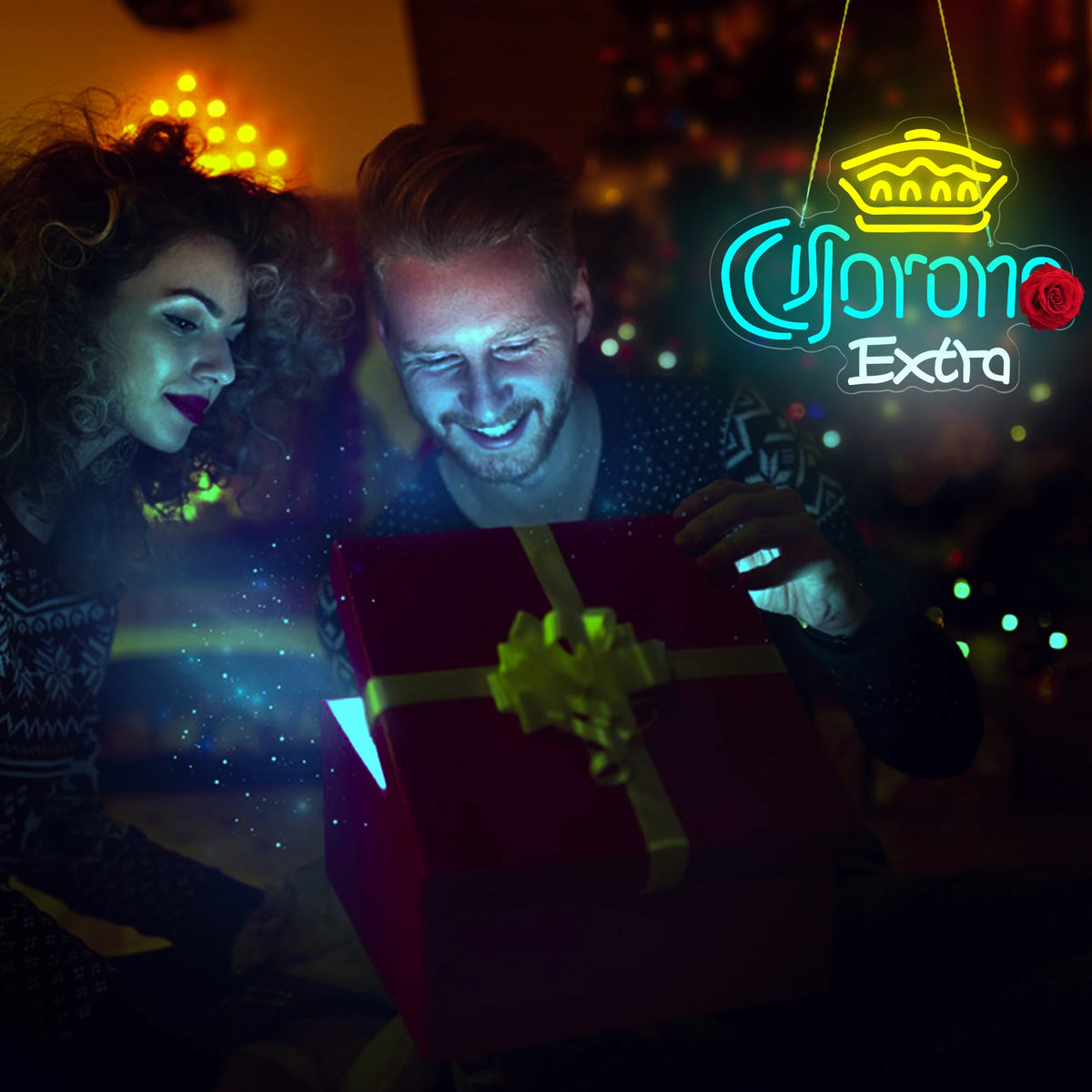 A man is opening a red gift box in front of a neon sign that reads Corona Extra.