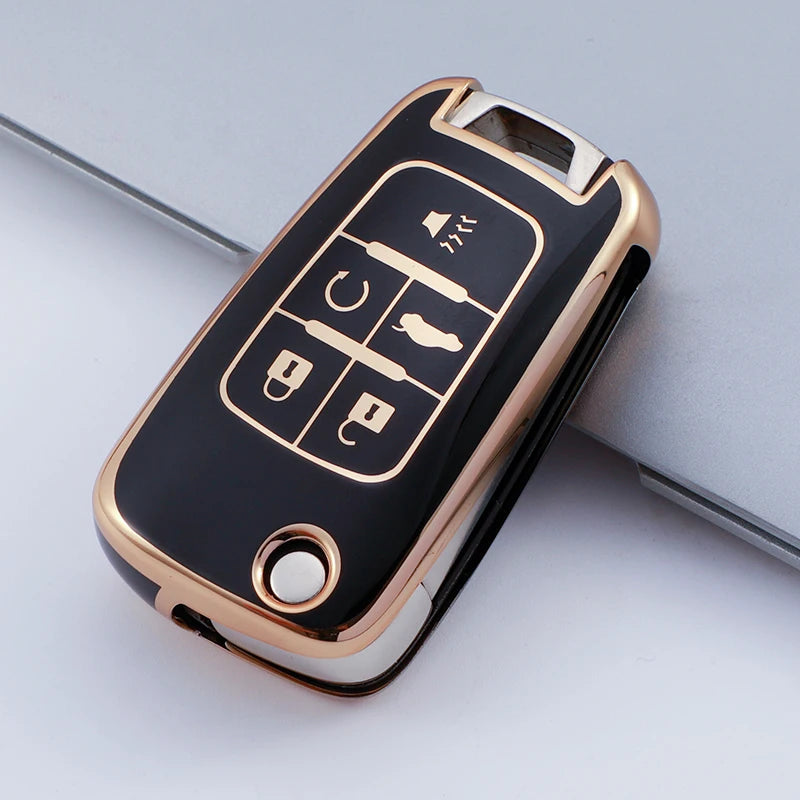 A black and gold protective TPU key fob cover for a vehicle, showing various buttons.