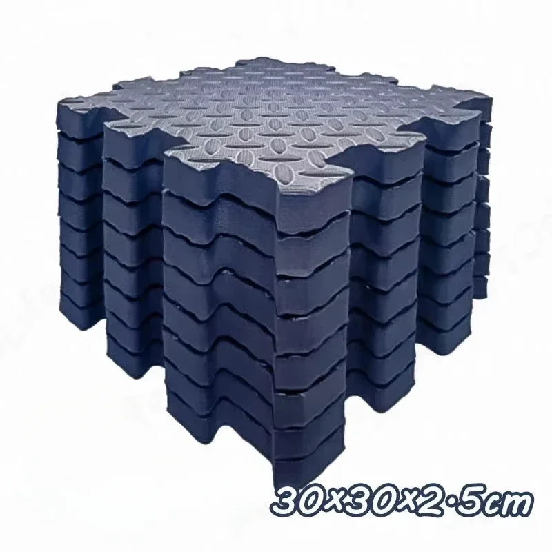 A stack of dark blue interlocking foam play mats with a textured surface, measuring 30x30x2.5cm.