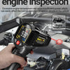 A hand holds an automotive engine infrared thermometer measuring the temperature of an engine component.