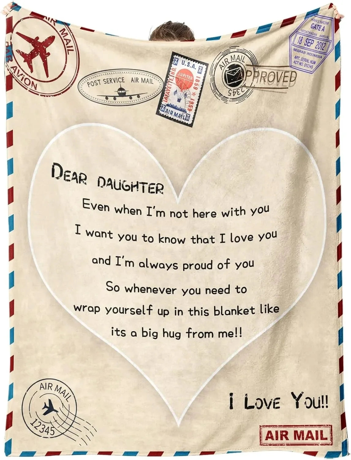 A cream-colored fleece throw blanket with a heart design and text expressing love and pride for a daughter.
