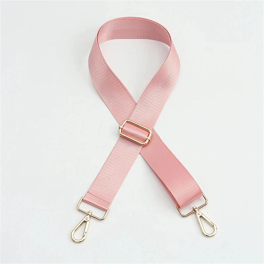 Pink nylon bag strap with a gold buckle shown diagonally.