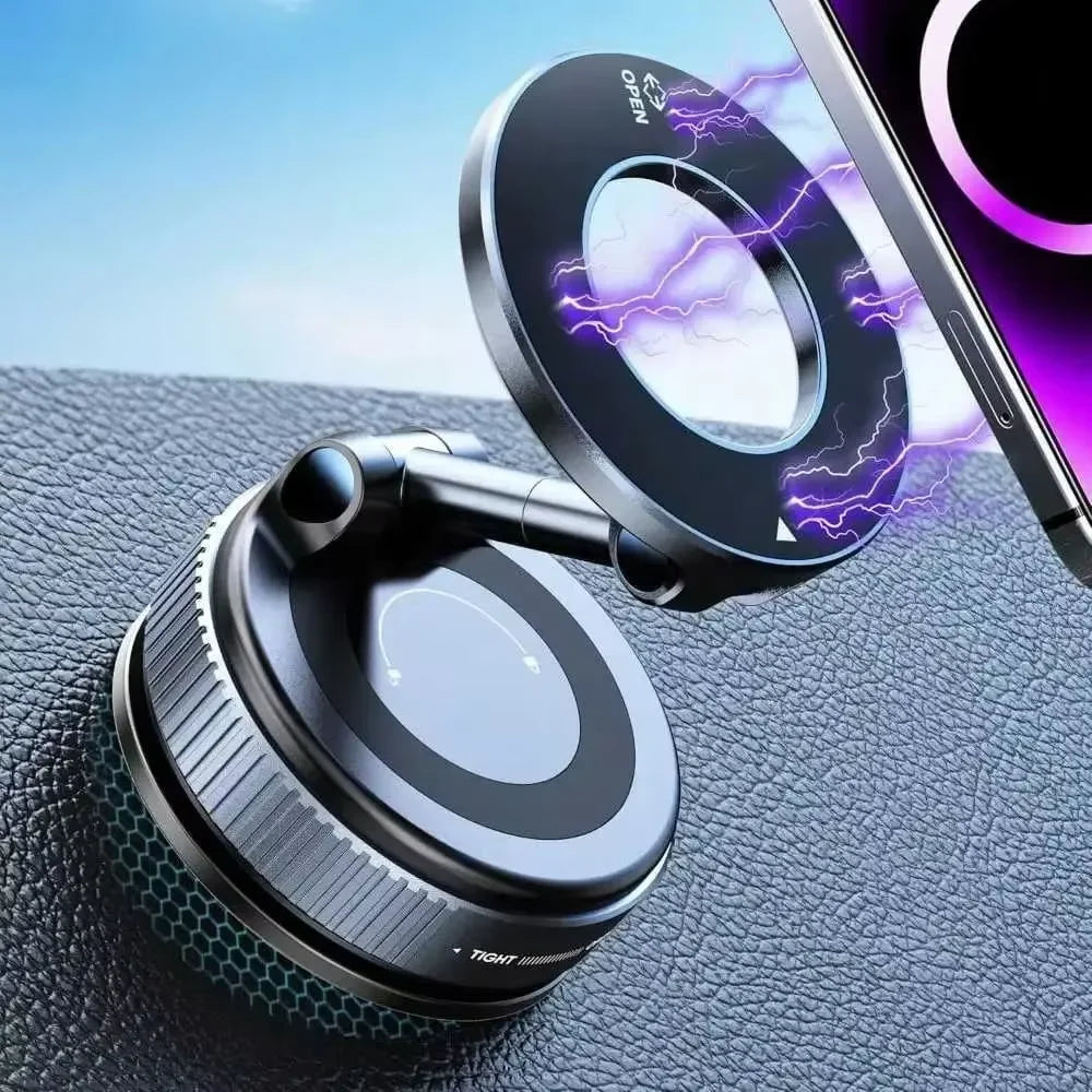 A close-up of a magnetic car phone mount with a rotating lens and vacuum suction cup placed on a dark surface.