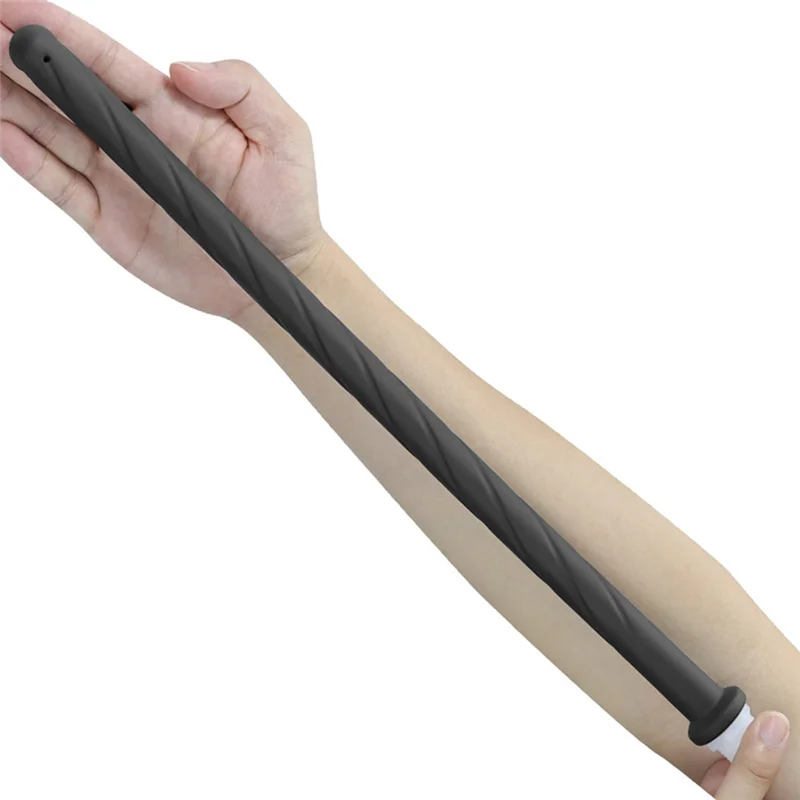 A hand is holding a black silicone handheld bidet sprayer for toilet.