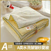 A lightweight summer quilt with a playful cartoon print featuring yellow and white patterns.