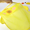 A hand is holding a bright yellow mesh bag shaped like a cartoon duck for bath toy storage.