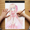 A hand is drawing a transparent LED tracing light for artists on a sheet of paper.