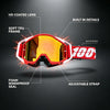 A close-up view of red off-road motorcycle goggles with a yellow lens, highlighting features like HD coated lens and soft TPU
