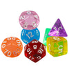 A set of seven transparent crystal polyhedral dice including a pink, blue, and red die.