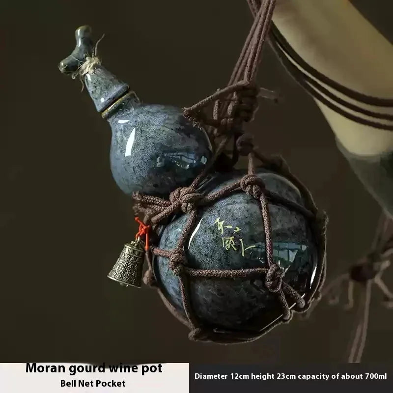 Moran gourd wine pot a dark blue ceramic bottle with a metal bell attached and a net bag