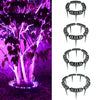 A tree is illuminated by purple LED lights, with a ground spike light visible at the base.