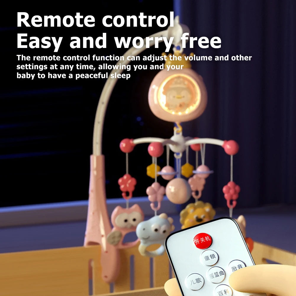 A hand holds a remote control for a baby crib mobile with a projector and night light.