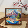 Diamond painting kit featuring a colorful sunset mountain landscape with trees and water.