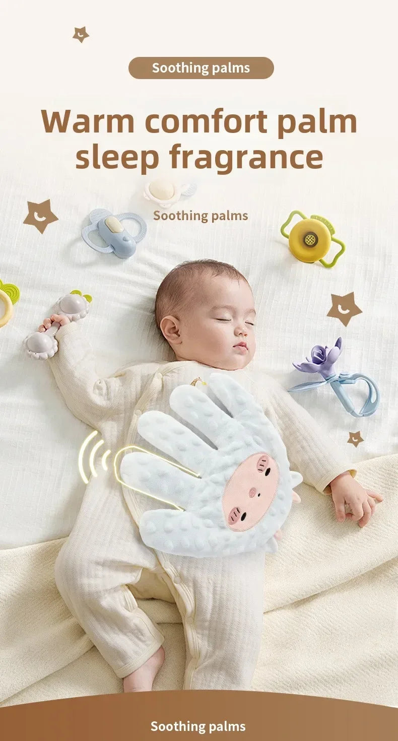 A baby is sleeping peacefully on a white blanket with a soothing palm-shaped silicone hand pillow.