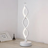 A white, USB-powered desk lamp shaped like a swirling seaweed, emitting a soft ambient glow.