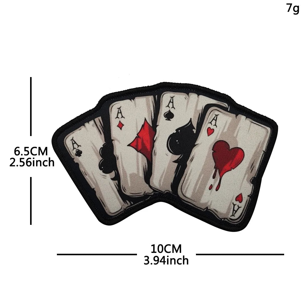 A set of five embroidered playing card patches featuring aces and a skull design with hook and loop backing.