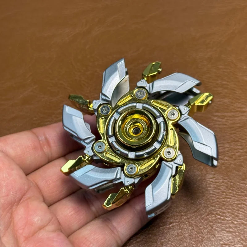 A metal fidget spinner with silver and gold components is held in a hand against a brown leather background.