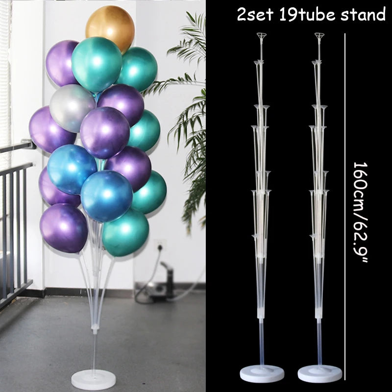 A set of two 19-tube clear plastic balloon column stands for party decor displayed against a white wall.
