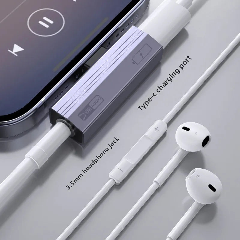 A white USB-C to 3.5mm audio adapter with a charging port and two white earphones is shown next to a smartphone.