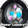 Close-up of reusable laundry balls in various colors floating in water inside a black washing machine drum.