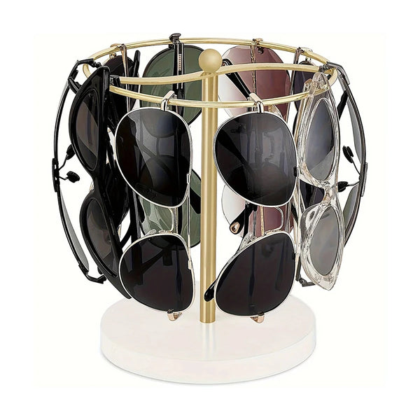 A gold-toned stand holding twelve pairs of sunglasses on a circular wooden base.