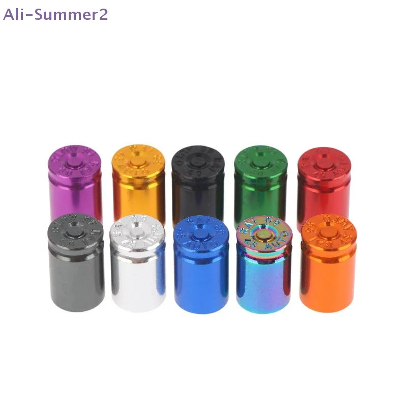 A set of four colored bullet shell tire valve stem caps in purple, gold, black, blue, green, and red.