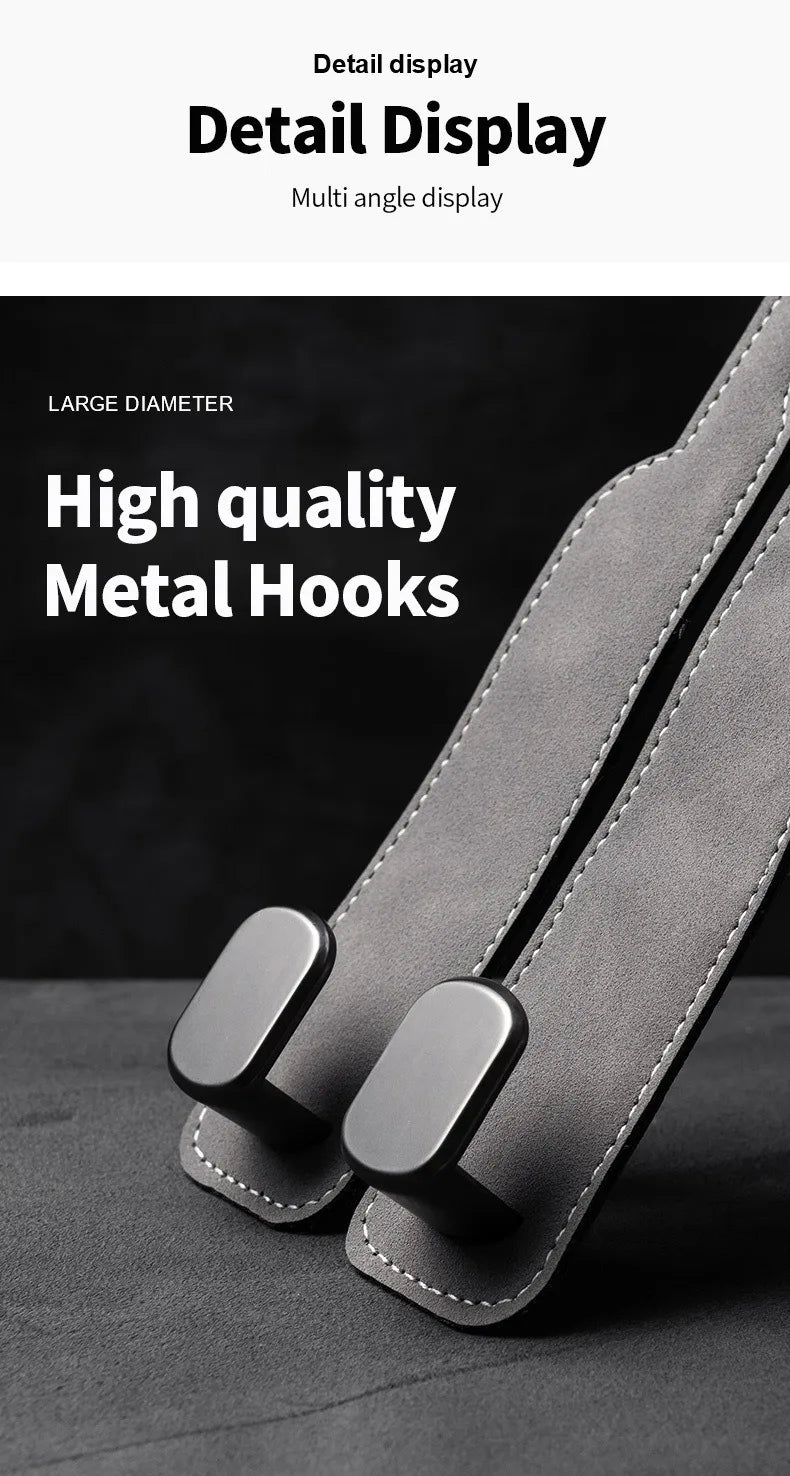 Close-up of large diameter metal hooks attached to a suede strap for car seat back storage.