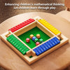 A wooden shut the box dice game with colored dice arranged in compartments on a green board.
