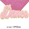 Pink glitter chenille letter patch spelling the word Dance on a pink grid background