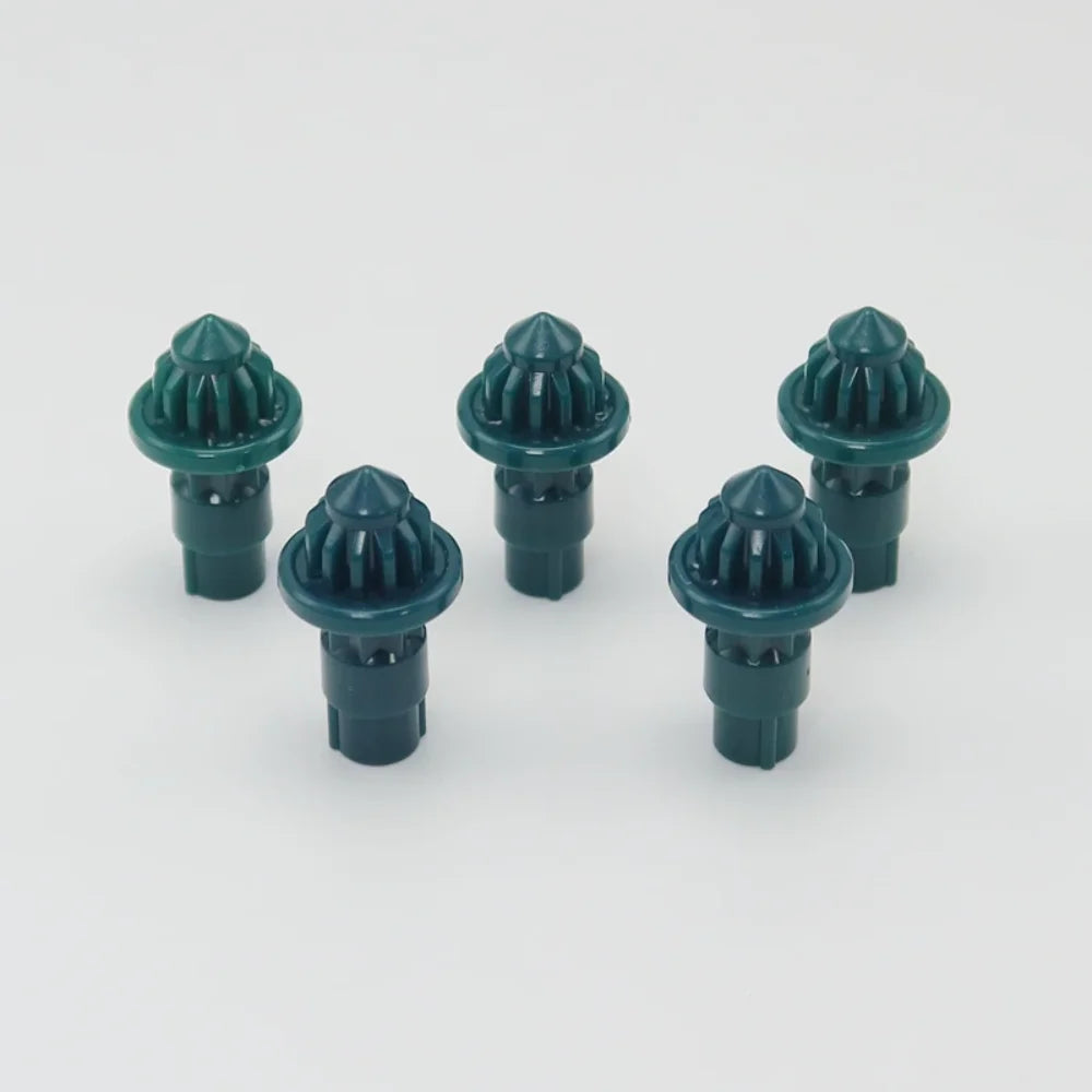 A set of five green replacement drivers for a battling top, used for fixing or adjusting the mechanism.