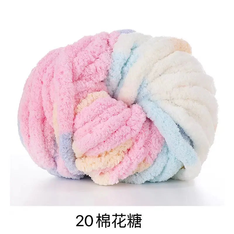 A ball of pink, blue, and white chunky acrylic yarn for knitting and crochet