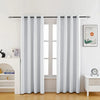 White floral blackout curtain panels hanging in a window frame.