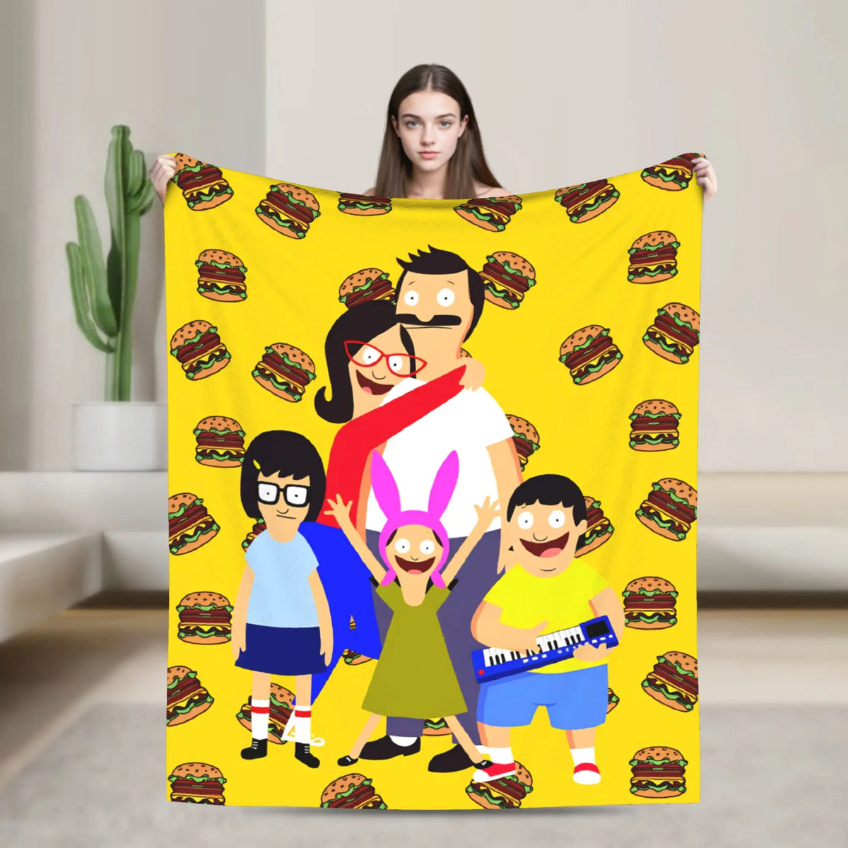 A playful cartoon blanket featuring a woman and a man with hamburgers and a child in a yellow background.