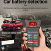 A hand holds a red 12V car battery detection tester with an LED display, connected to a vehicle's electrical system.