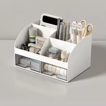 A white desk organizer with multiple compartments and transparent drawers holding pens, tools, and accessories.