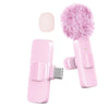 A pink wireless lavalier microphone with a fluffy pink foam cover and a clip attachment.