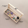 A wooden gift box containing twelve natural amethyst crystal stones.