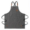 A dark gray cotton canvas apron with cross-back straps and multiple pockets.