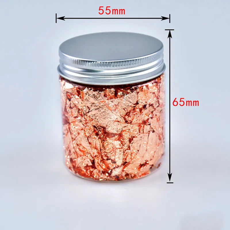 A glass jar filled with metallic rose gold foil flakes, sealed with a silver lid.