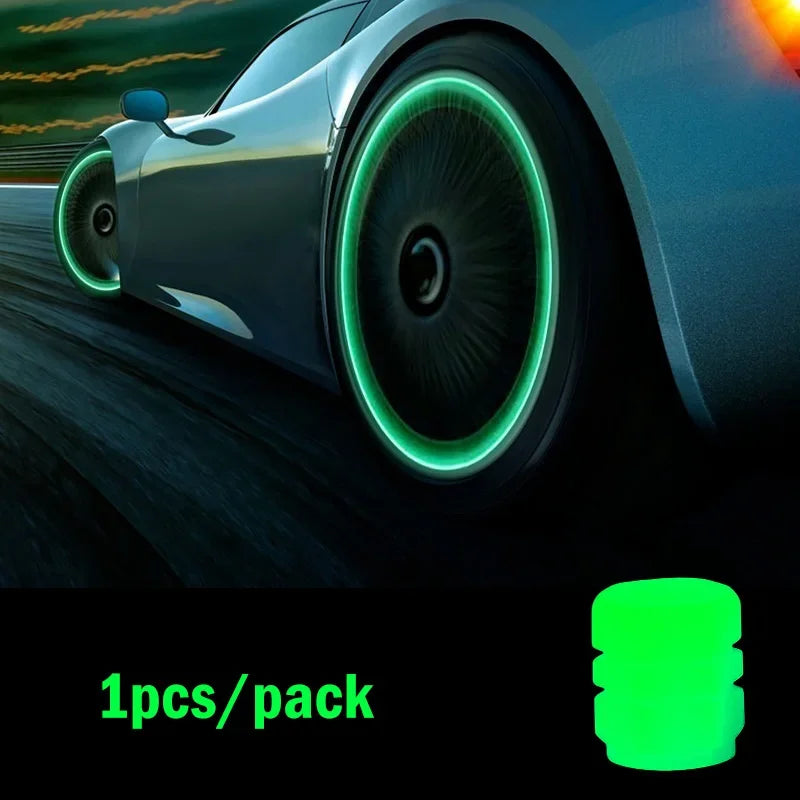Close-up of a car wheel with a luminous green glow-in-the-dark tire valve cap on a dark road.