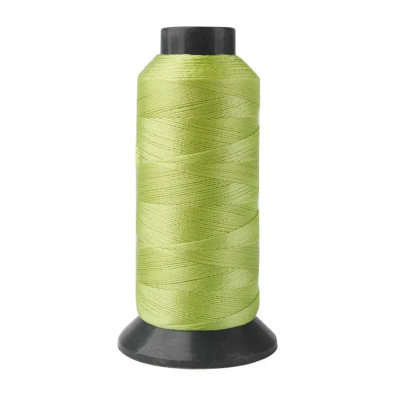 A spool of light green heavy-duty nylon sewing thread for upholstery and denim.