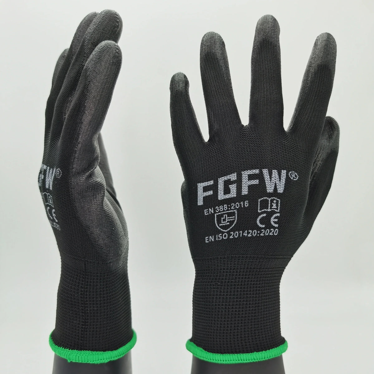 A pair of black breathable PU-coated work gloves with green trim shown against a light gray background.