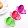 A set of heat-resistant silicone finger covers in various shades of pink and green for baking and cooking.