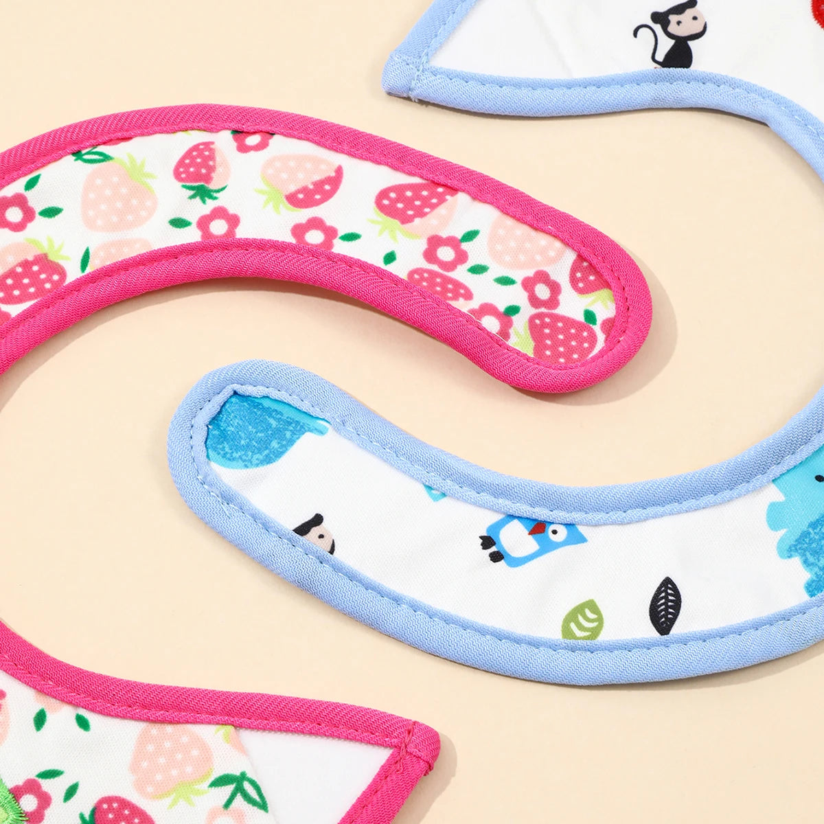 A set of colorful waterproof baby bibs and burp cloths featuring various cartoon prints like strawberries and animals.
