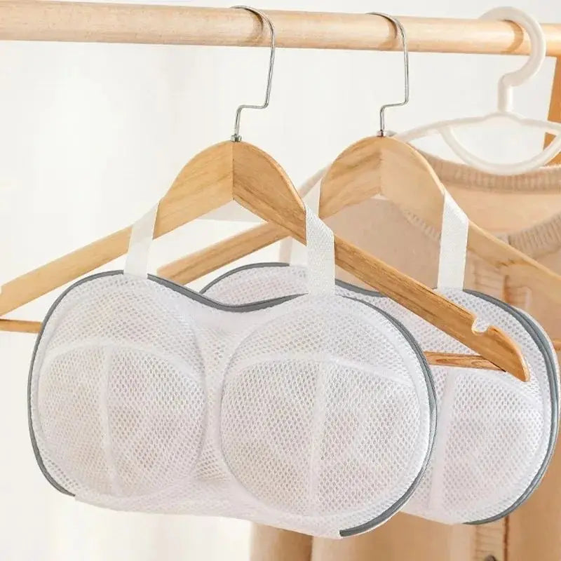 White fine mesh laundry bag for delicate underwear hanging on a wooden hanger